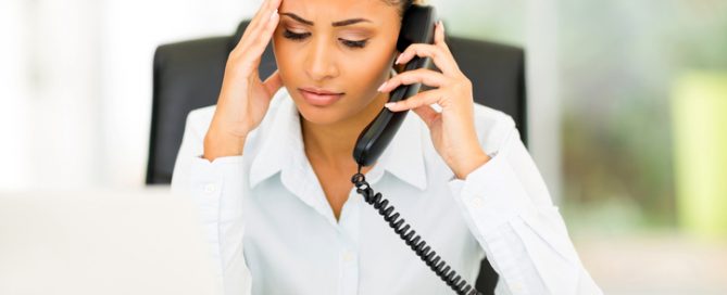 Worried woman talking to IRS debt collector