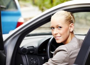 Smiling woman after obtaining cheaper car insurance
