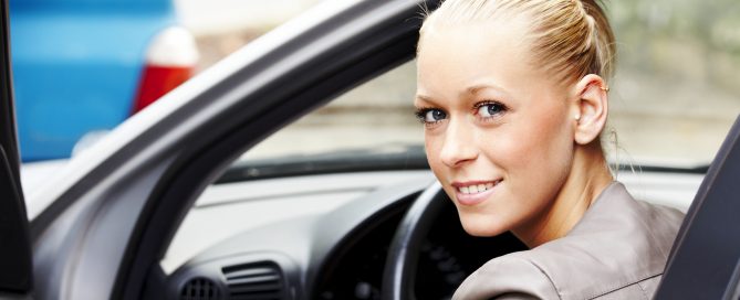 Smiling woman after obtaining cheaper car insurance