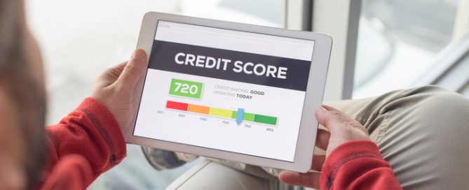 Man looking at credit score in tablet