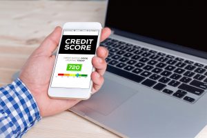 Man holding cellphone with free credit score on screen